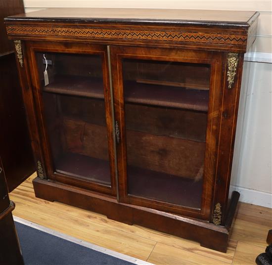 A Victorian walnut two door cabinet W.114cm